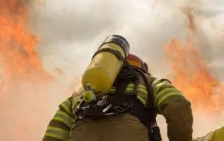 A group of firemen attacking a fire with water. some brave firemen doing teamwork against fire