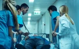 Emergency room personnel, doctors and nurses moving patient