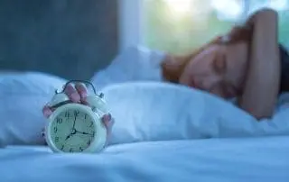 Young, fatigued nurse trying to get the last bit of sleep