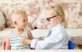 serious little doctor examining patients